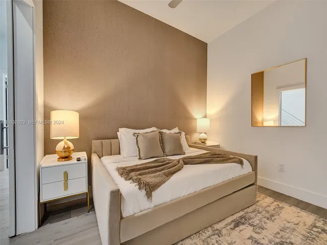 a living room with wooden floor and stairs