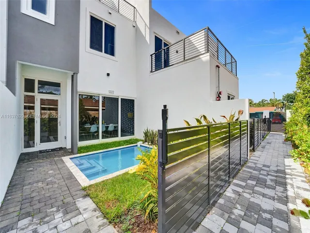 a view of a balcony with two chairs and a table