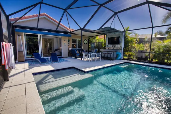 a view of a patio with table and chairs under an umbrella