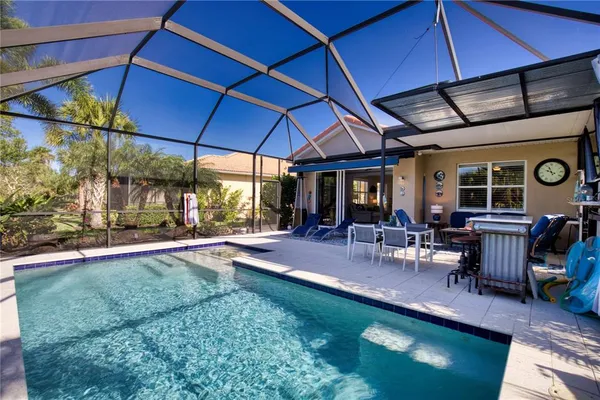 a view of a backyard with table and chairs under an umbrella