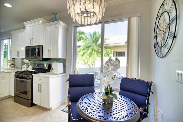 a living room with furniture a fireplace and a chandelier