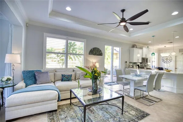 a living room with furniture a window and a chandelier