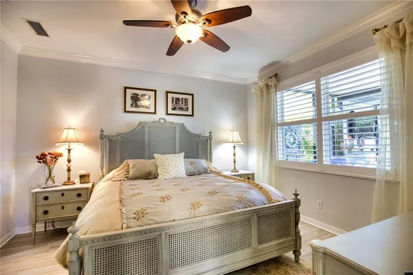 a bedroom with a bed and a chandelier