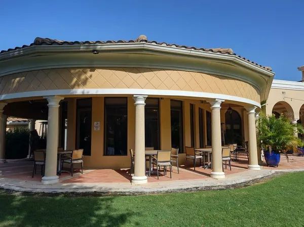 a dining room with furniture a chandelier and wooden floor