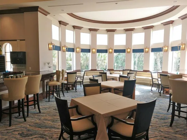 a view of a patio with couches table and chairs and potted plants