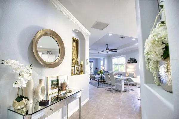 a living room with furniture a fireplace and a chandelier