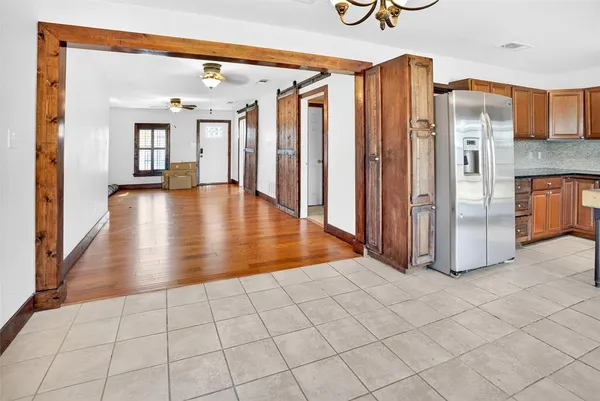 a view of a livingroom with kitchen and furniture