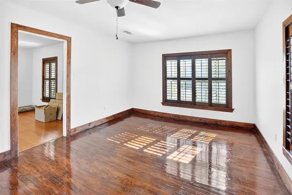 a view of empty room with wooden floor