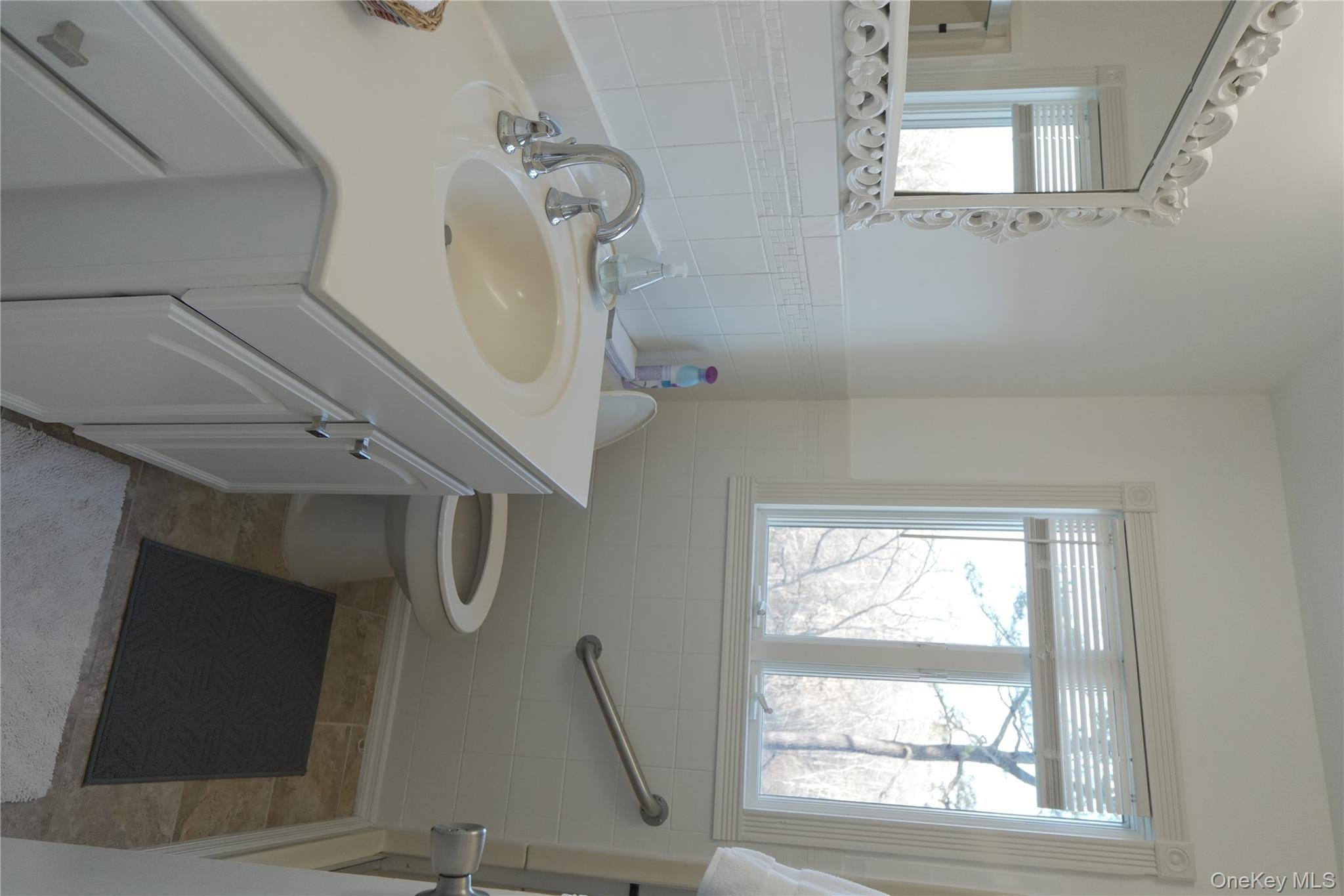 371 South River Road Calverton, NY 11933 - Photo 13 of 24 a bathroom with a sink toilet and window