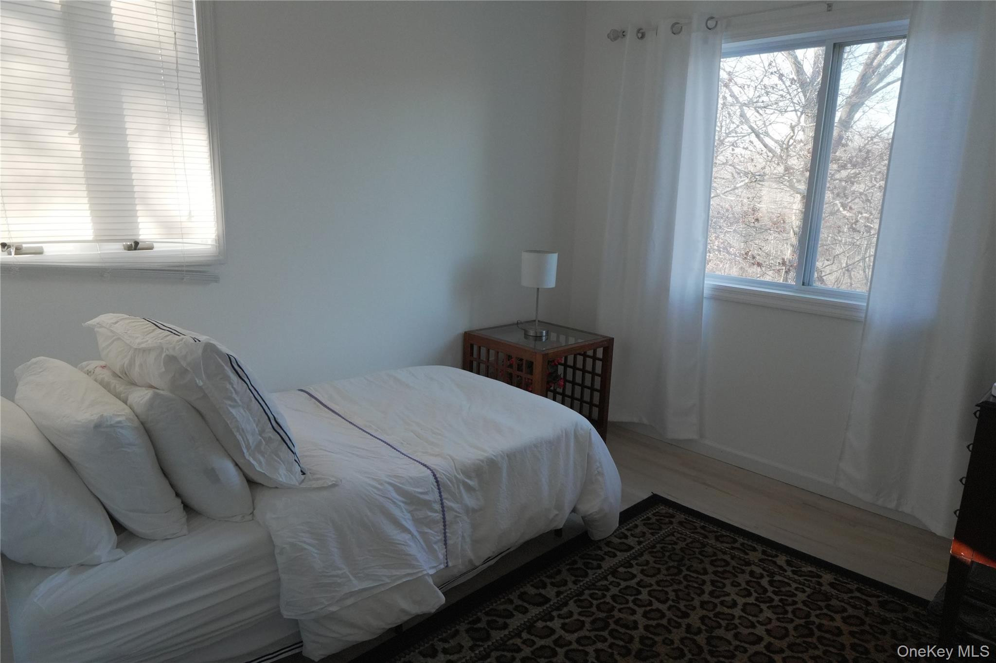 371 South River Road Calverton, NY 11933 - Photo 17 of 24 a bedroom with a bed and a window