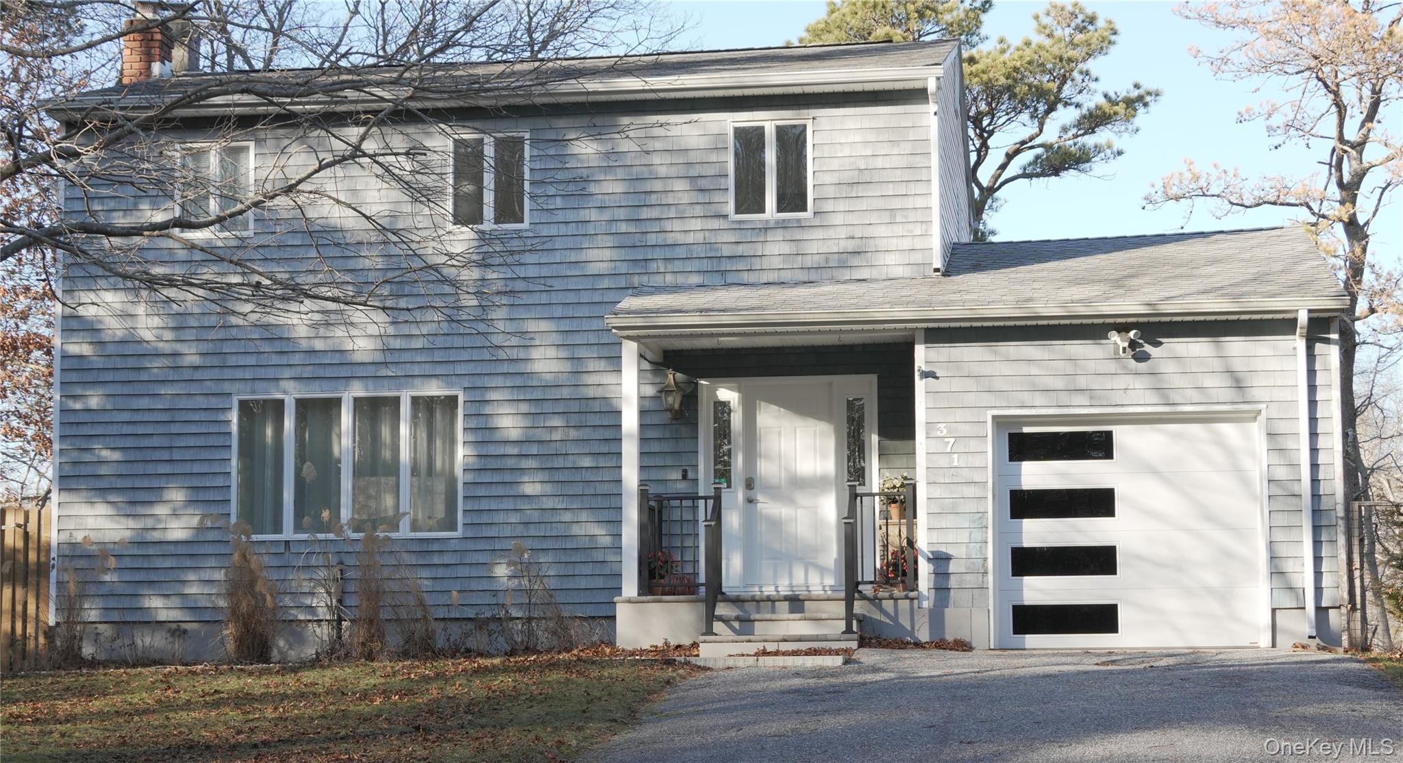 371 South River Road Calverton, NY 11933 - Photo 2 of 24 a view of a brick house with large windows
