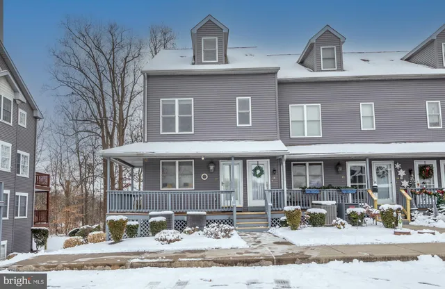 front view of a house with a bench