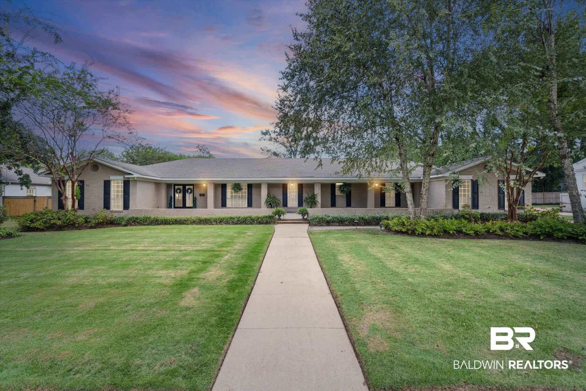 254 Woodlands Avenue Mobile, AL 36607 - Photo 1 of 50 Ranch-style home with a porch, a front lawn, and brick siding