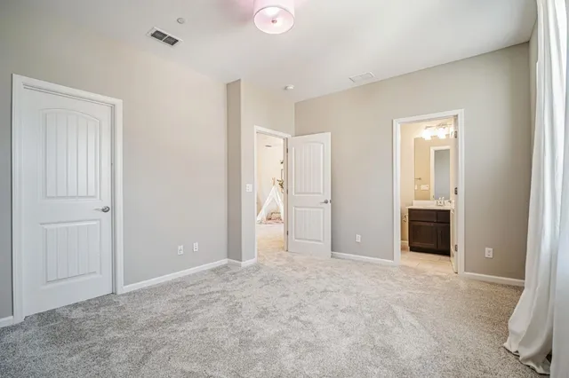 a spacious bathroom with a double vanity sink a mirror a bathtub and next to a window