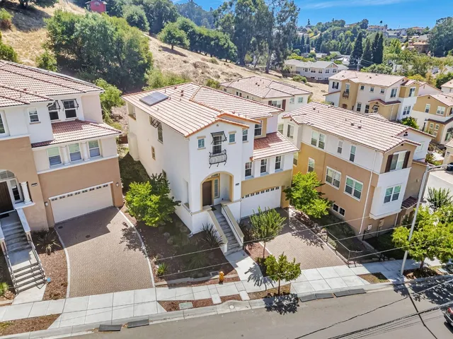 a bedroom with a bed and a potted plant