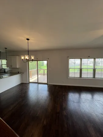 a kitchen with stainless steel appliances granite countertop a sink a stove and a refrigerator