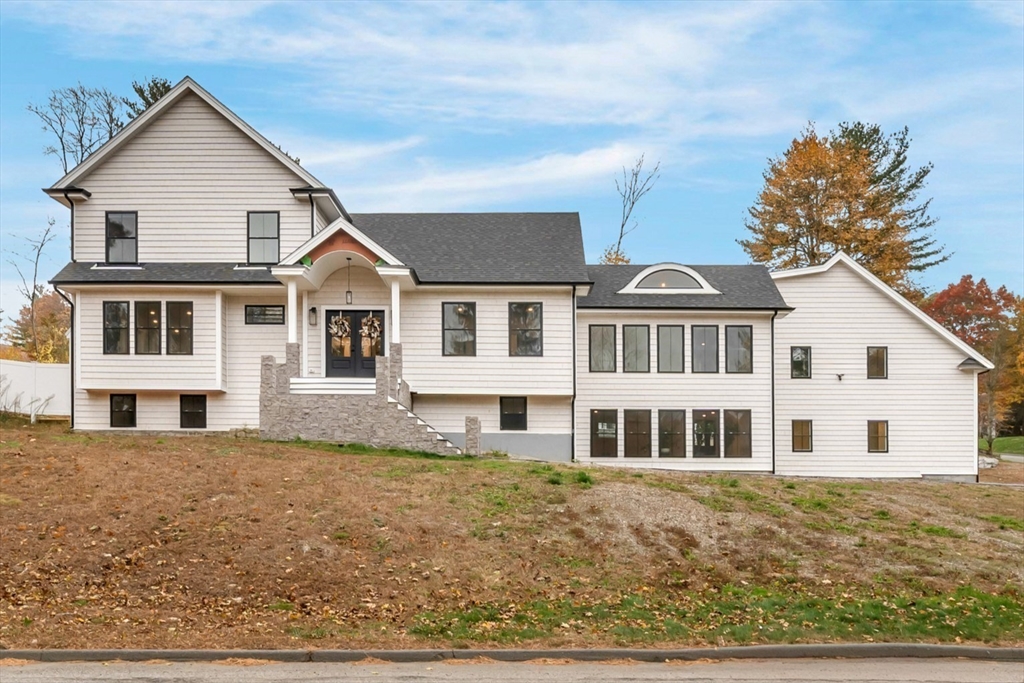4 Lowell Street Lynnfield, MA 01940 - Photo 1 of 42 a front view of a house with a garden