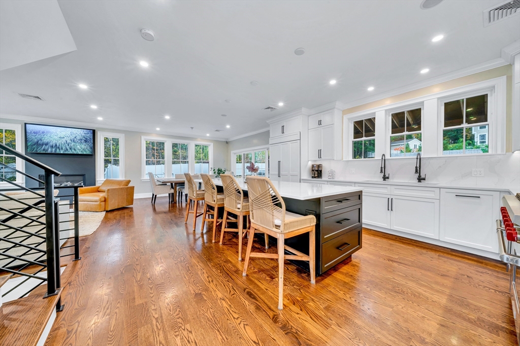 4 Lowell Street Lynnfield, MA 01940 - Photo 2 of 42 a large dining hall with stainless steel appliances granite countertop a stove and a living room view