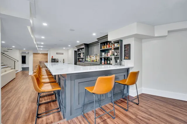 a living room with furniture and kitchen view