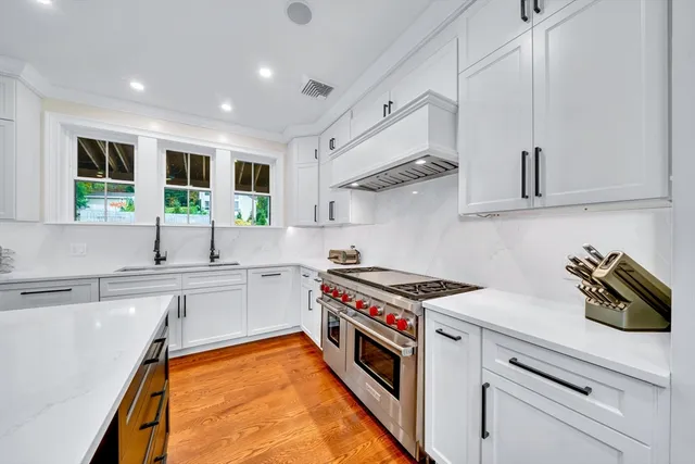a kitchen with stainless steel appliances granite countertop a sink and a stove