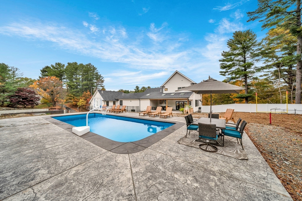 4 Lowell Street Lynnfield, MA 01940 - Photo 35 of 42 a view of a patio with swimming pool and sitting area