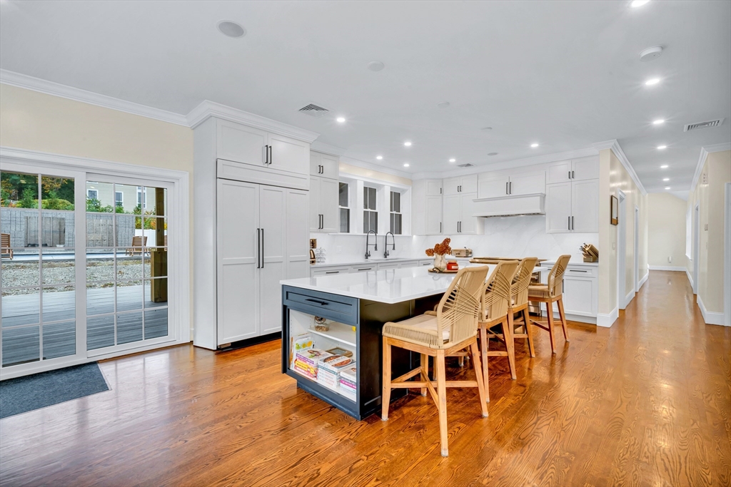 4 Lowell Street Lynnfield, MA 01940 - Photo 5 of 42 a kitchen with stainless steel appliances a dining table chairs and wooden floor