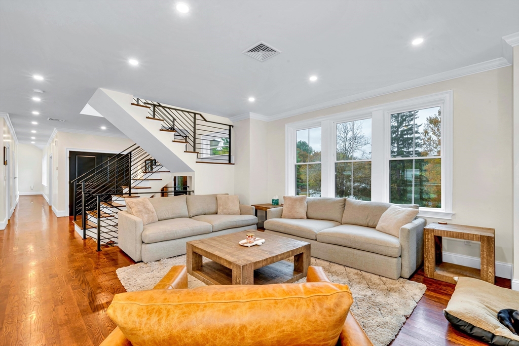 4 Lowell Street Lynnfield, MA 01940 - Photo 9 of 42 a living room with furniture wooden floor and a large window