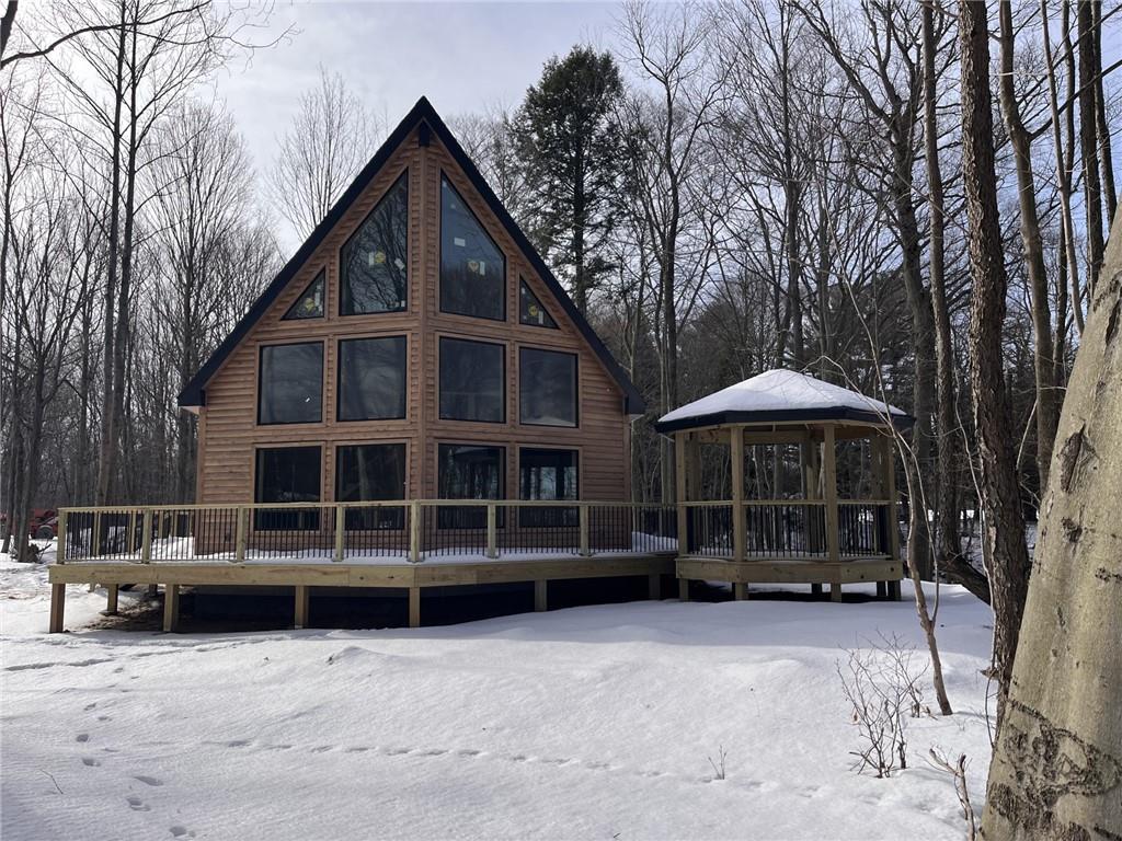 a view of a house with a yard and sitting area