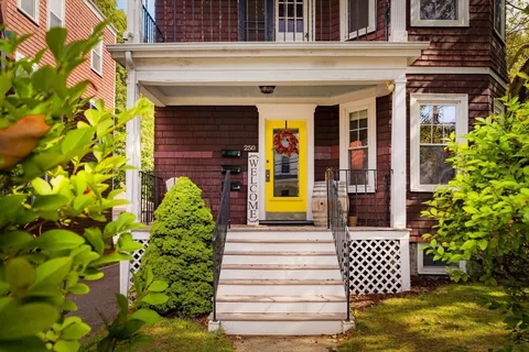 a front view of a house with a garden