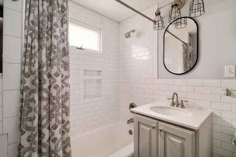 a bathroom with a sink toilet and shower