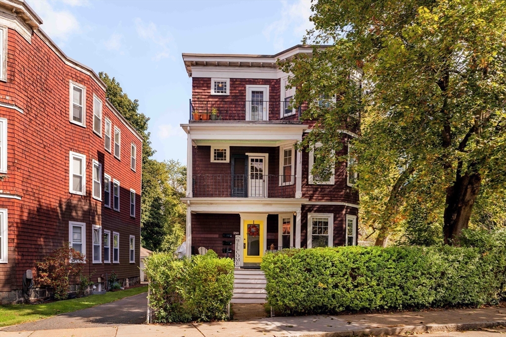 250 Poplar Street, Unit 1 Boston, MA 02131 - Photo 29 of 34 a front view of a residential apartment building with a yard