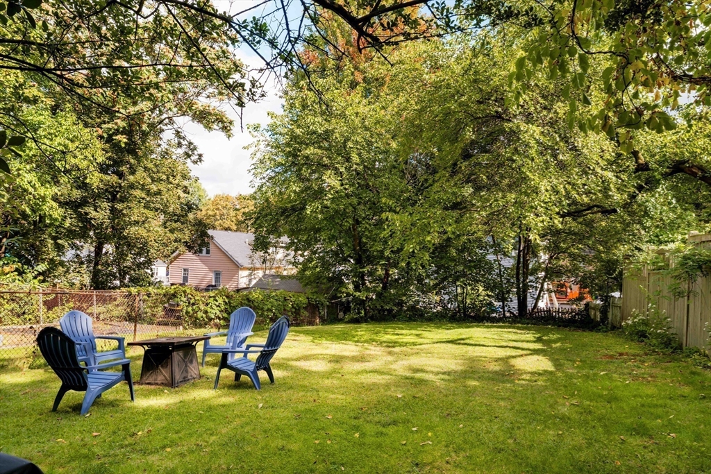250 Poplar Street, Unit 1 Boston, MA 02131 - Photo 32 of 34 a view of a swimming pool with a bench and trees