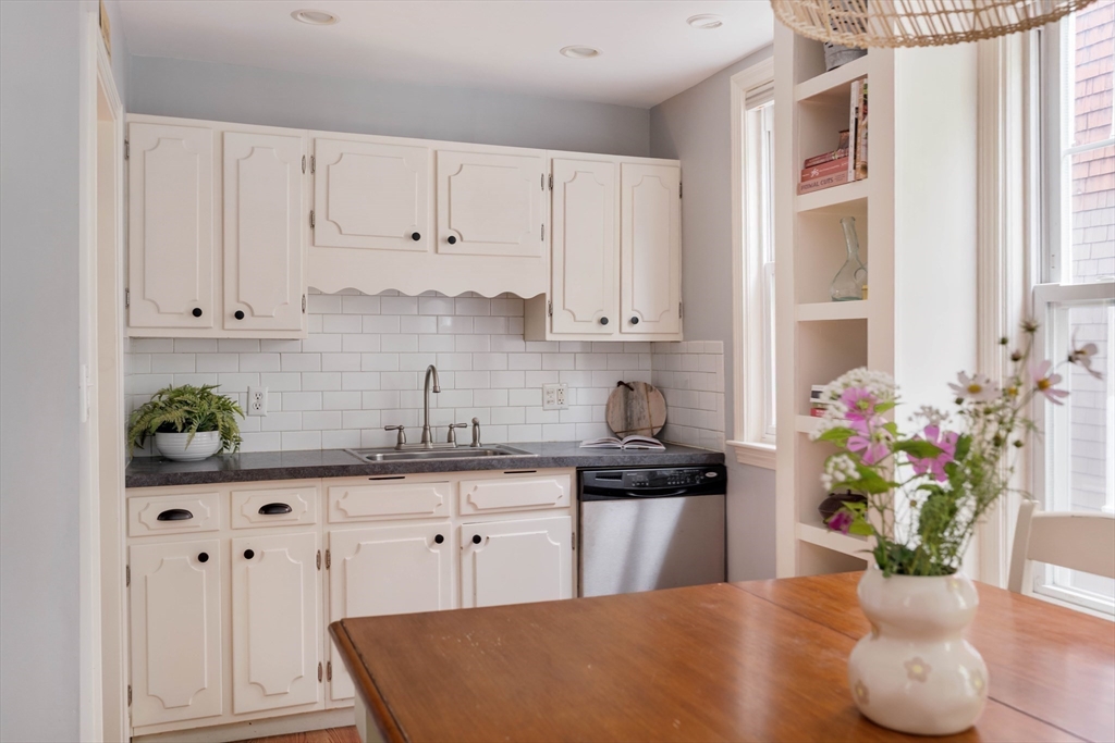 250 Poplar Street, Unit 1 Boston, MA 02131 - Photo 6 of 34 a kitchen with stainless steel appliances granite countertop a cabinets and a potted plant