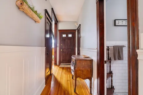 a view of hallway with wooden floor