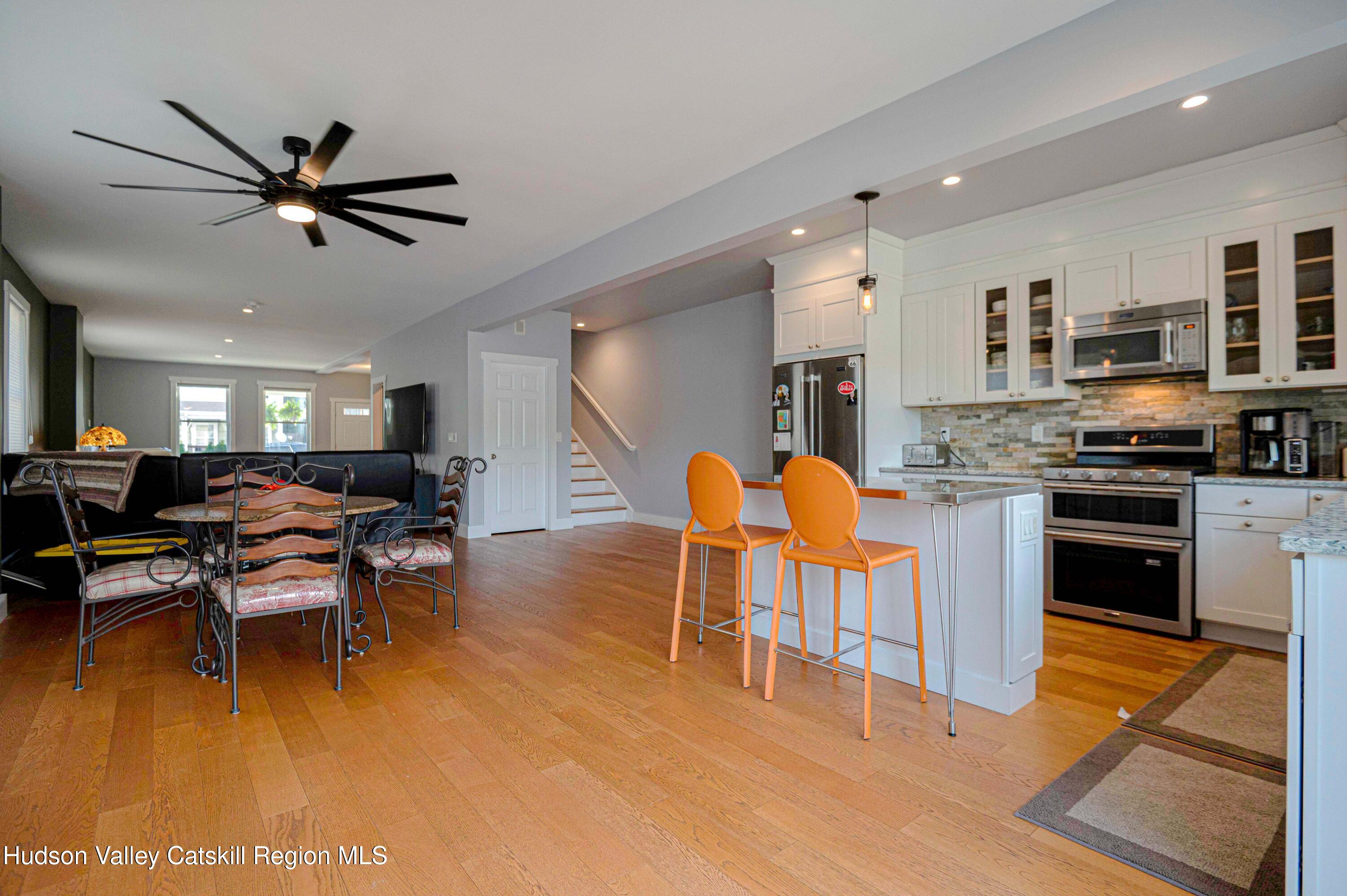 225 State Street, Unit RIGHT Hudson, NY 12534 - Photo 12 of 29 a living room with stainless steel appliances kitchen island granite countertop furniture and a dining table