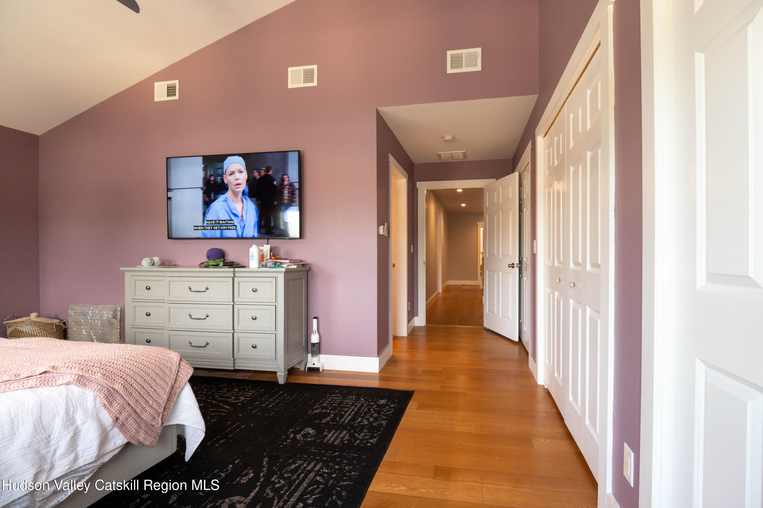 225 State Street, Unit RIGHT Hudson, NY 12534 - Photo 23 of 29 a bed room with a bed and painting on the wall