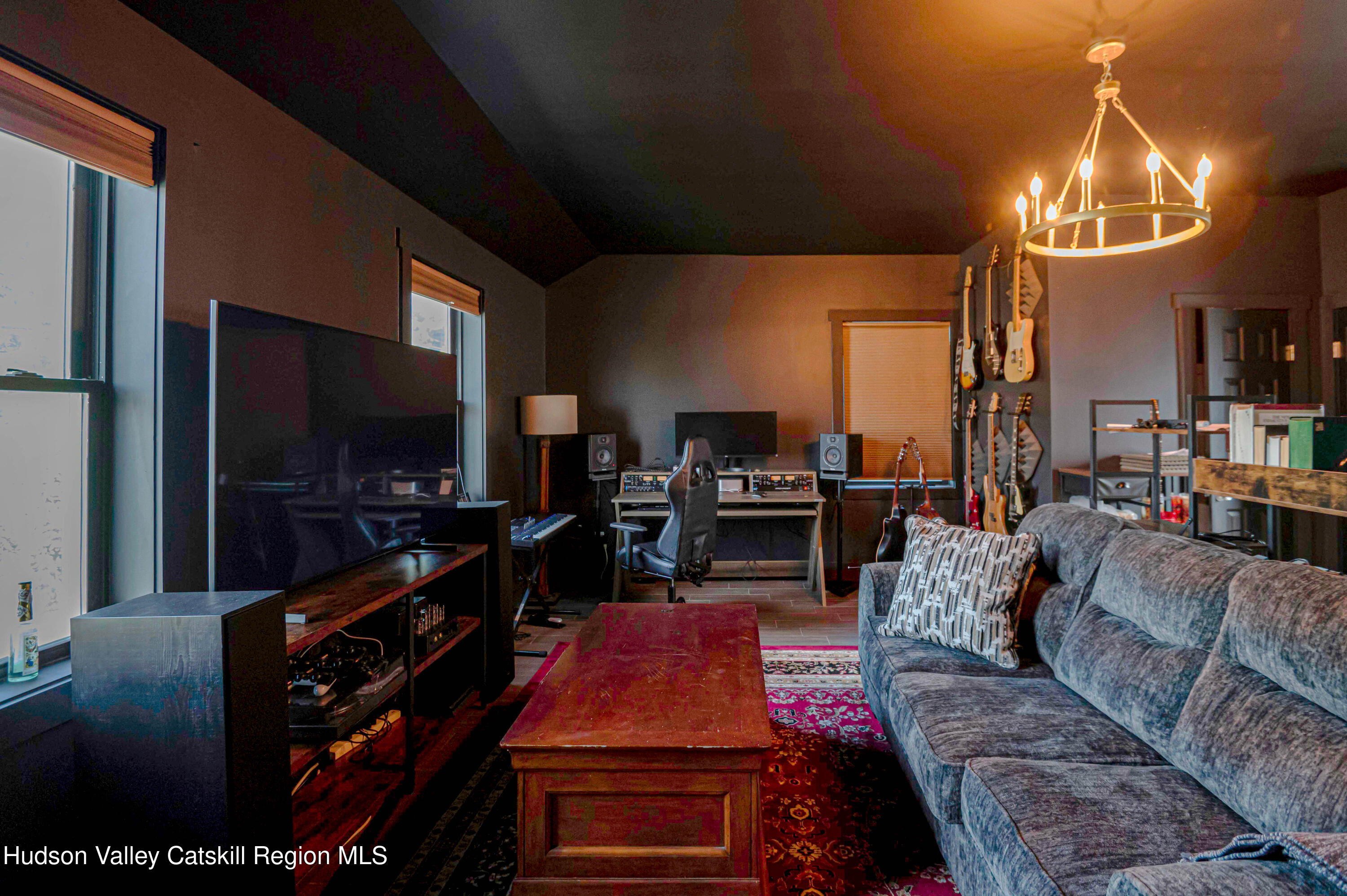 225 State Street, Unit RIGHT Hudson, NY 12534 - Photo 28 of 29 a living room with furniture and a flat screen tv