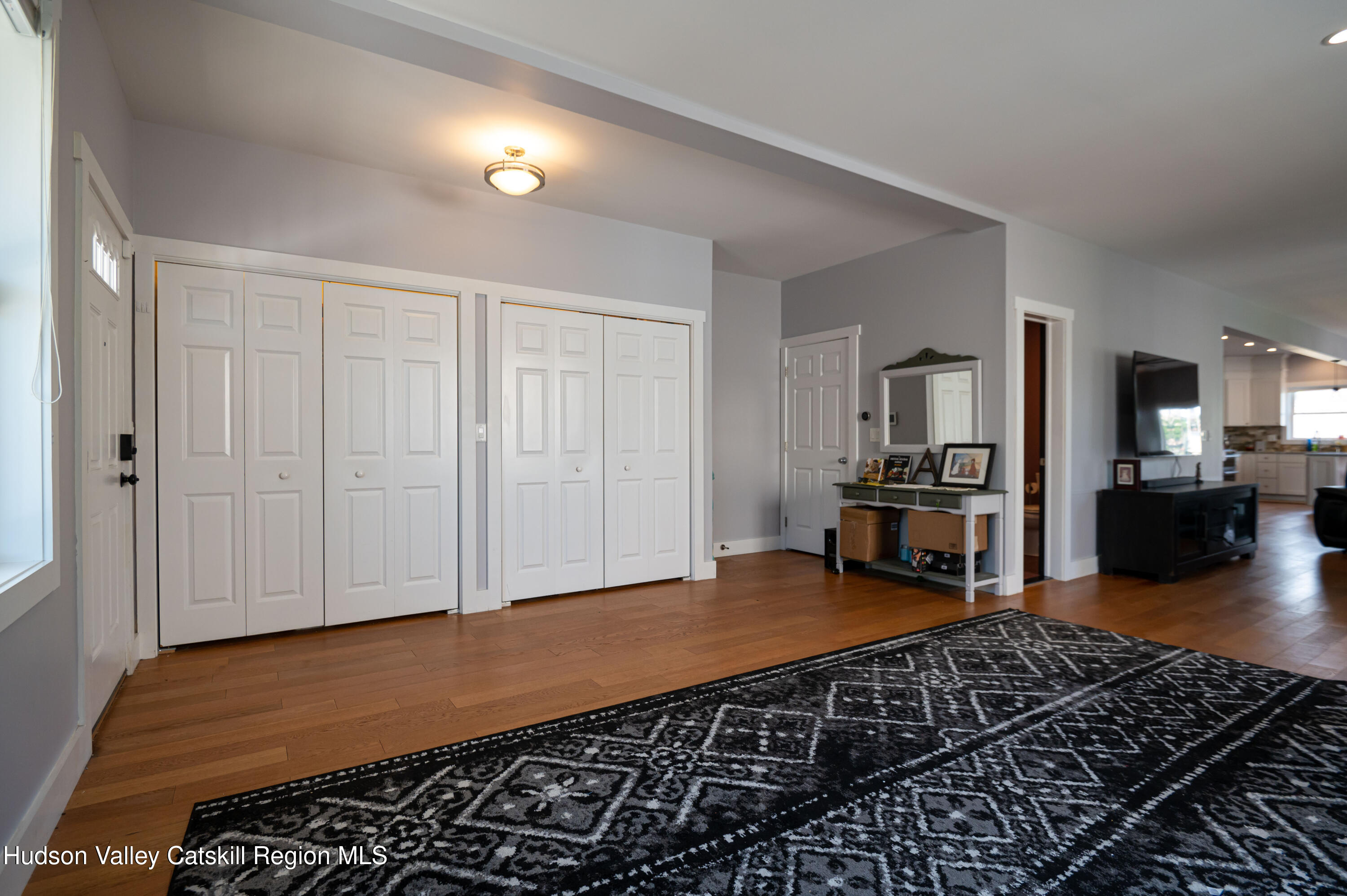 225 State Street, Unit RIGHT Hudson, NY 12534 - Photo 8 of 29 a living room with furniture and a wooden floor