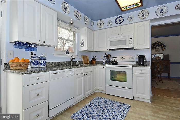 14424 Basingstoke Lane Silver Spring, MD 20905 - Photo 11 of 29 a kitchen with granite countertop white cabinets stainless steel appliances and a window