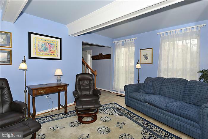 14424 Basingstoke Lane Silver Spring, MD 20905 - Photo 14 of 29 a living room with furniture a rug and a window