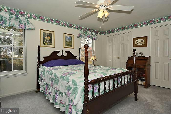 14424 Basingstoke Lane Silver Spring, MD 20905 - Photo 21 of 29 a bedroom with a bed and a chandelier