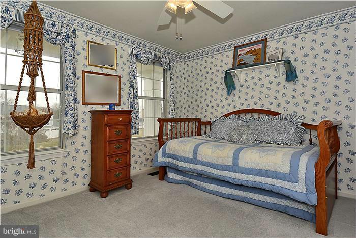 14424 Basingstoke Lane Silver Spring, MD 20905 - Photo 23 of 29 a spacious bedroom with a bed and a chandelier