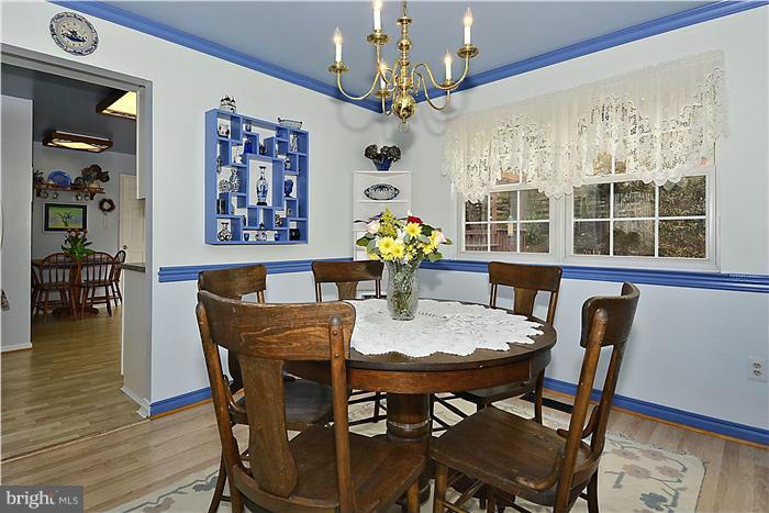14424 Basingstoke Lane Silver Spring, MD 20905 - Photo 9 of 29 a view of a dining room with furniture wooden floor and chandelier