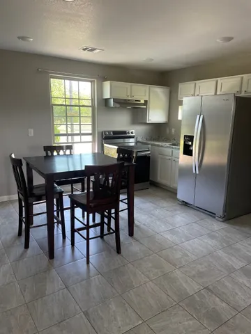 a kitchen with a table and chairs in it