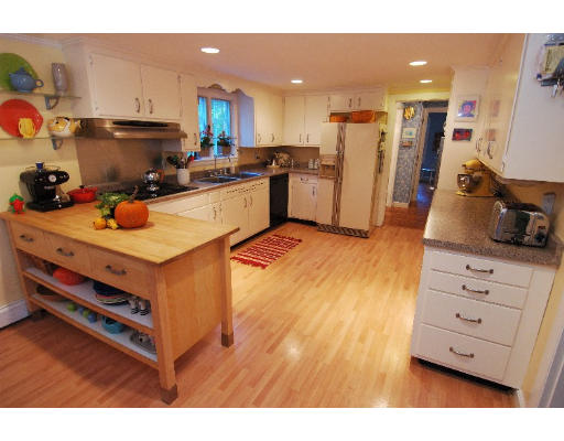 87 Concord Road Acton, MA 01720 - Photo 3 of 9 a kitchen view with stainless steel appliances a stove cabinets and a window