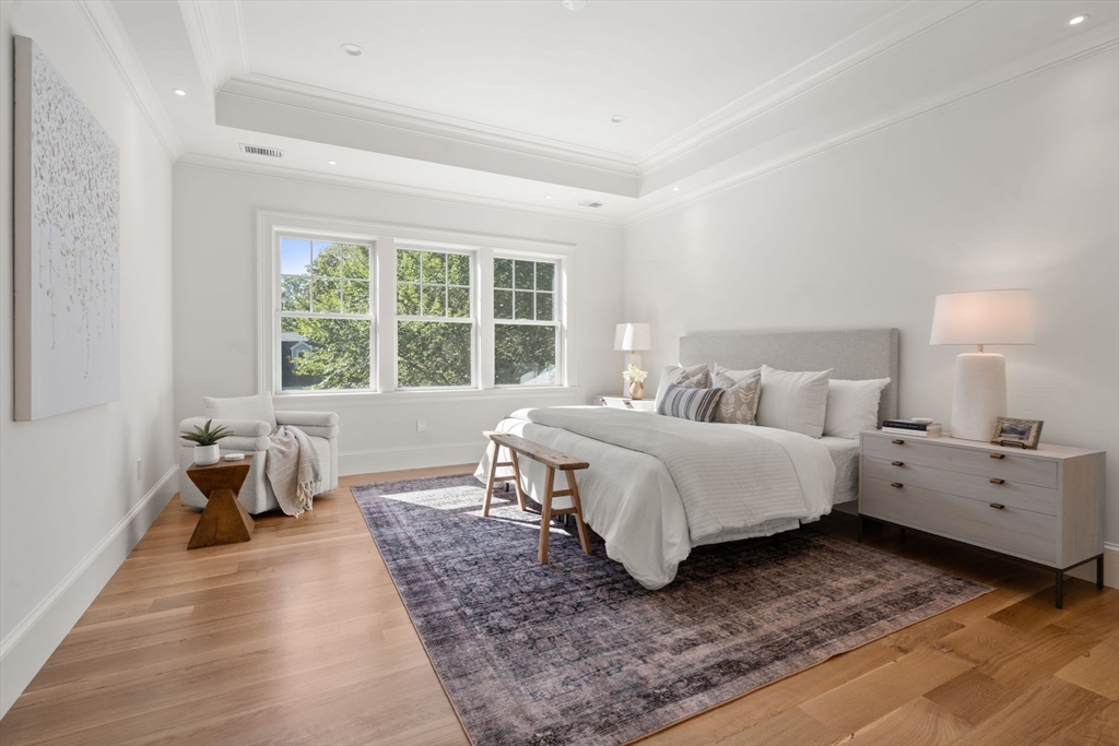 32 South Woodside Avenue Wellesley, MA 02482 - Photo 22 of 42 a bedroom with a bed and large windows