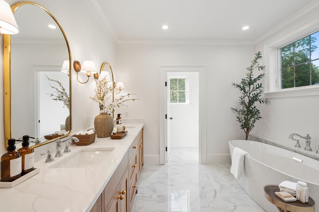 32 South Woodside Avenue Wellesley, MA 02482 - Photo 24 of 42 a bathroom with a granite countertop sink a large mirror and a bathtub