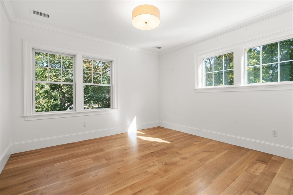 32 South Woodside Avenue Wellesley, MA 02482 - Photo 30 of 42 a view of an empty room with wooden floor and a window