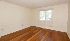1 Upland Circle, Unit 1 Mashpee, MA 02649 - Photo 12 of 39 an empty room with wooden floor and windows