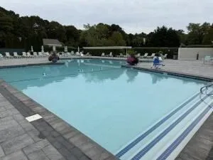 a view of swimming pool with chairs